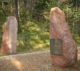Two large stone slabs mark the entrance to the Martin’s Trail in the forest