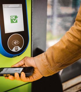 Ticket scan with smartphone at a reader, display shows “OK” confirmation.